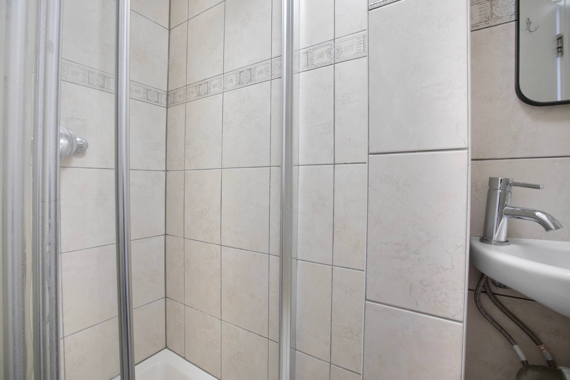 Top floor shower room with glass enclosure
